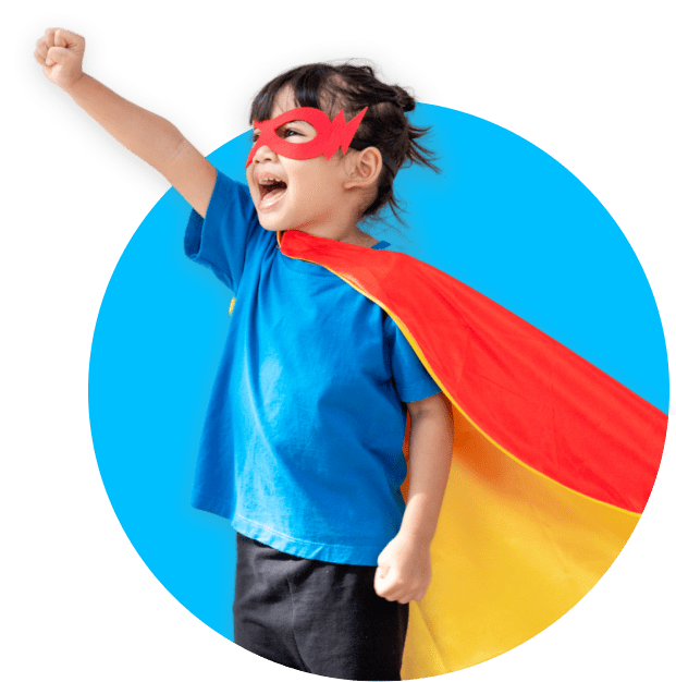 Smiling child in a superhero cape and mask standing confidently, symbolizing mission and potential