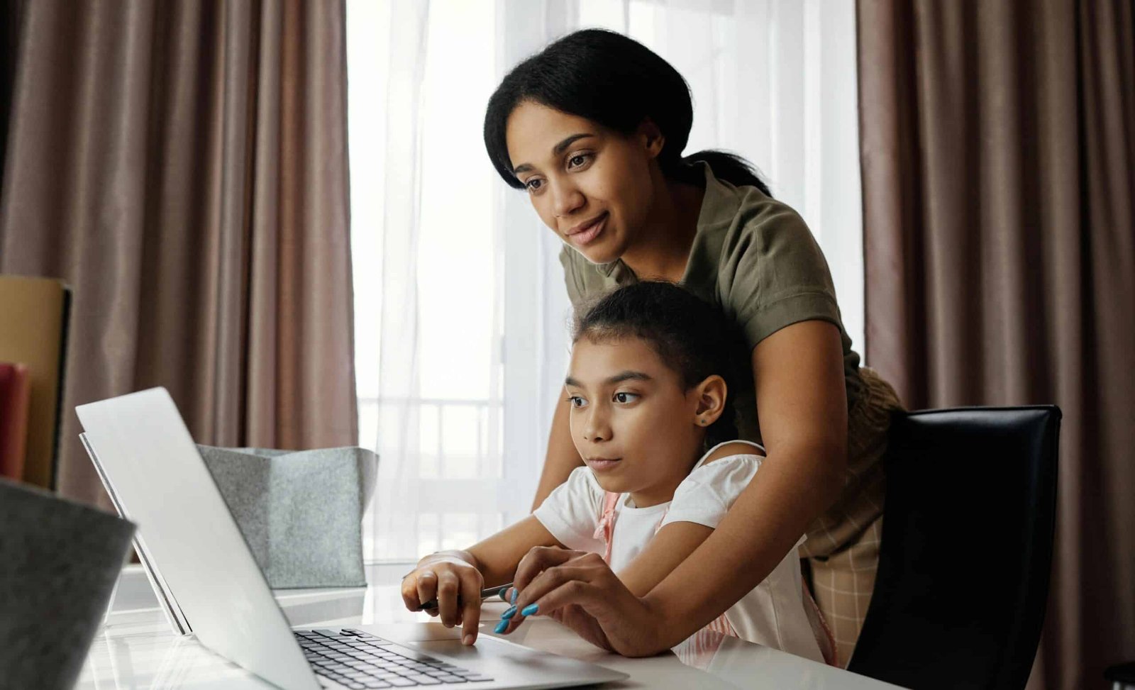 Mother and child using a laptop.